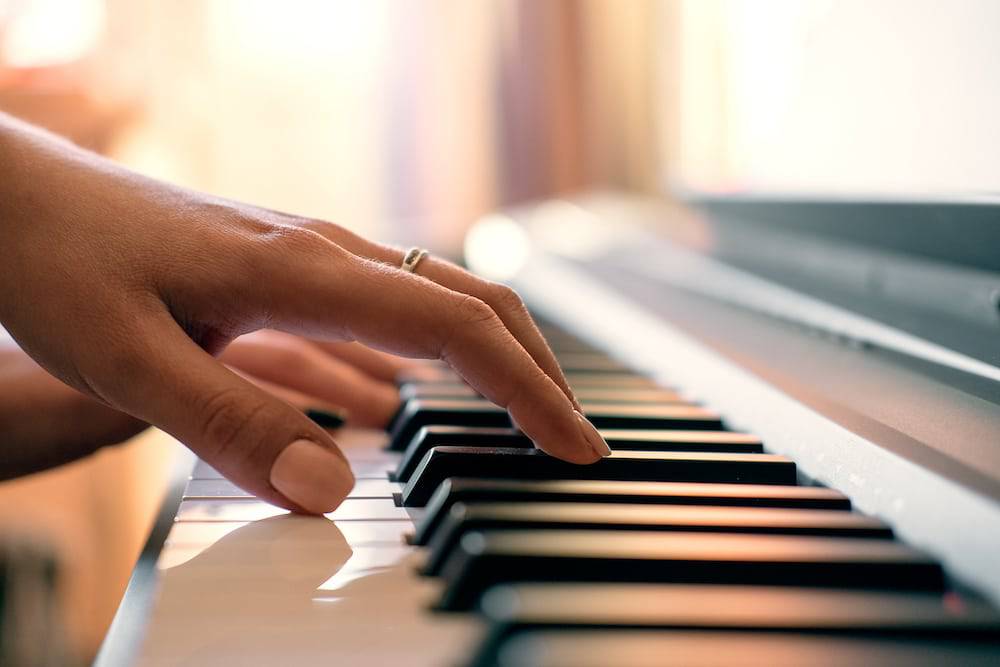 A close up shot of hands playing the piano