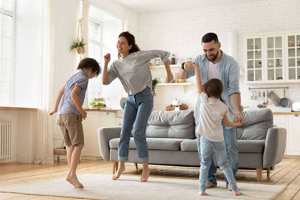Family dancing in living room