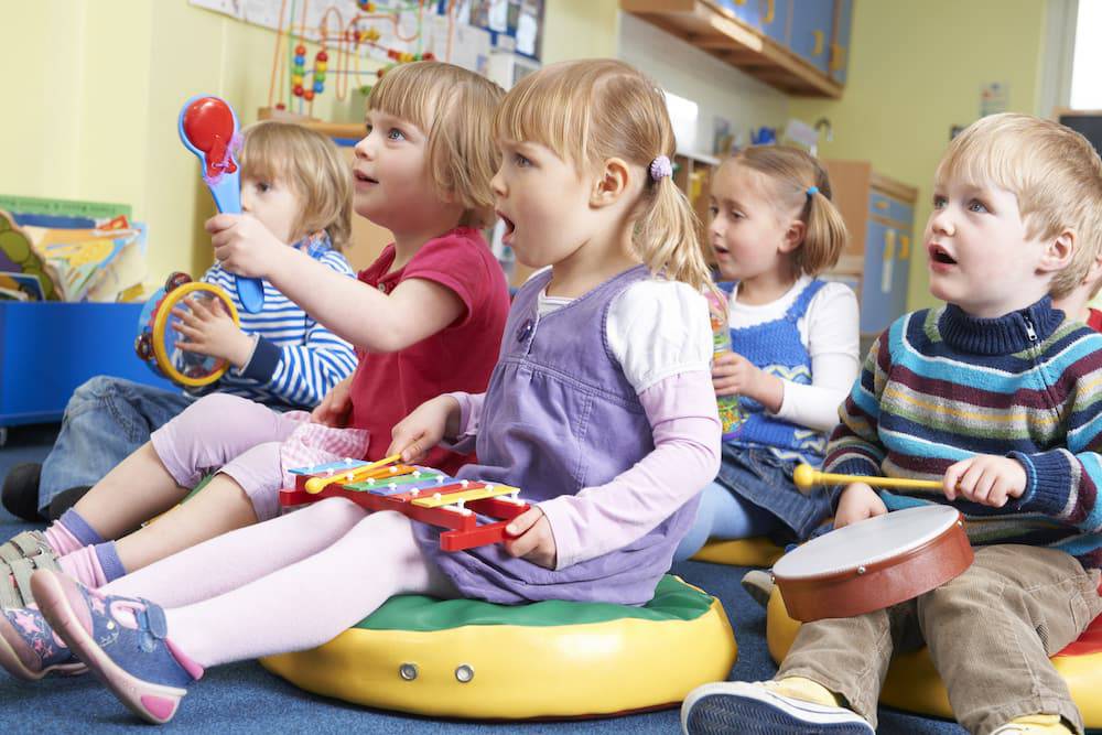 A group of children participate in music class