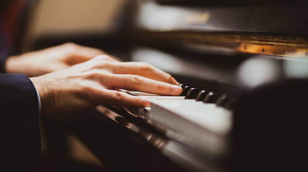 Man playing piano in music lessons kansas city.