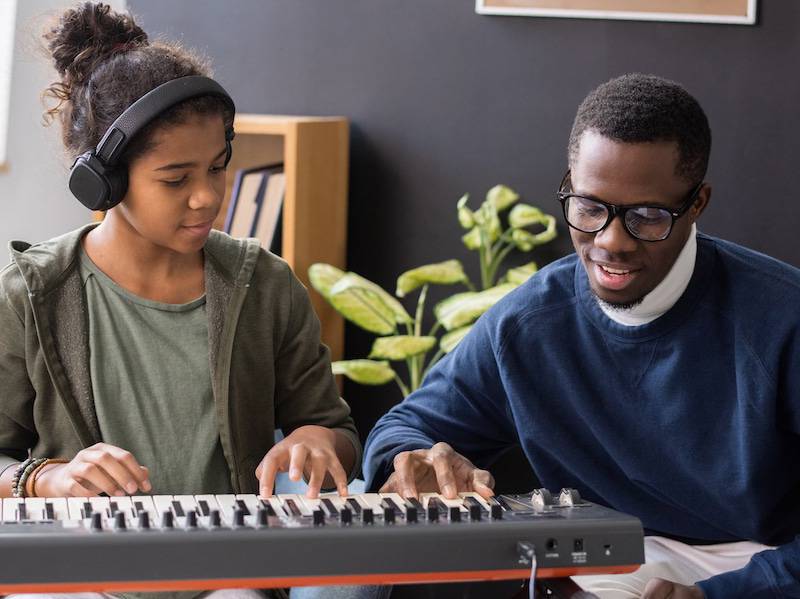 Student learning piano with music lessons in Kansas City