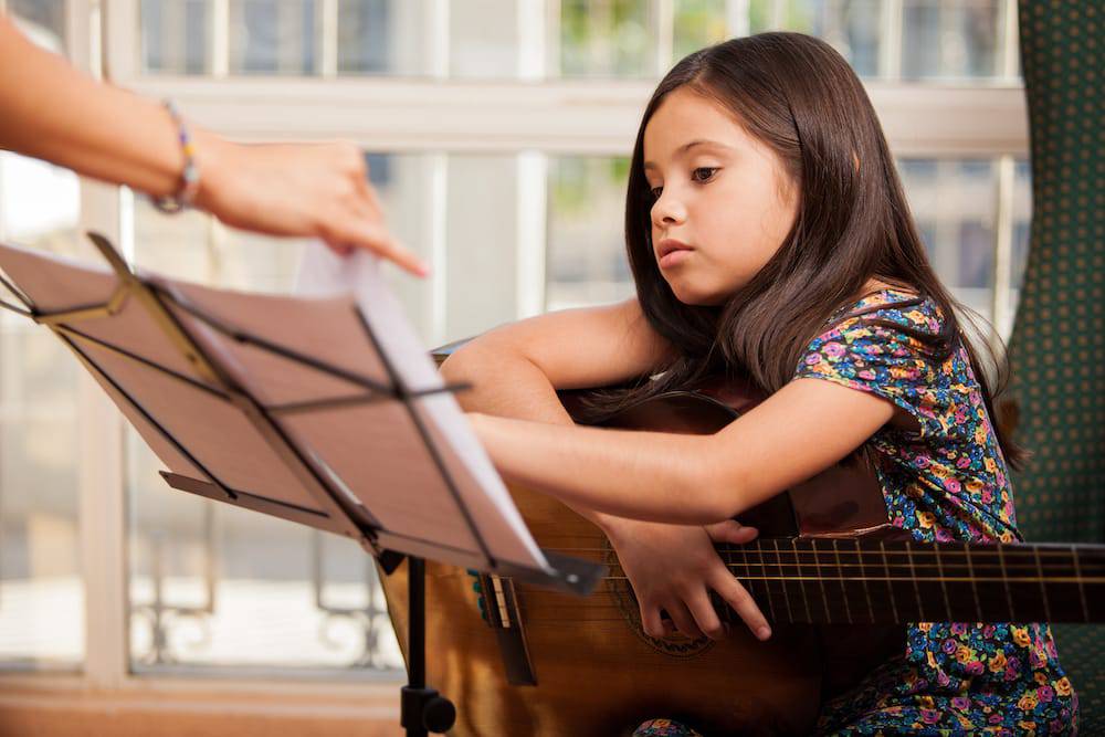 A young girl taking private music lessons in Kansas City