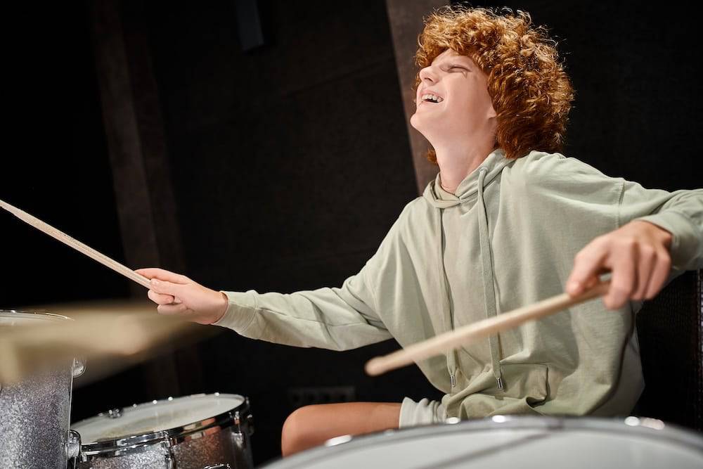 Teenager playing the drums because he searched for drum lessons near me